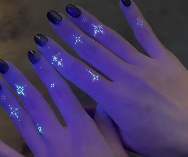 gtartistoo fluorescent tattoo ink glow effect art on fingers under UV light