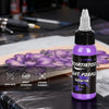 Light purple tattoo ink 1 oz bottle displayed with a purple flower tattoo design on practice skin | GTARTISTOO